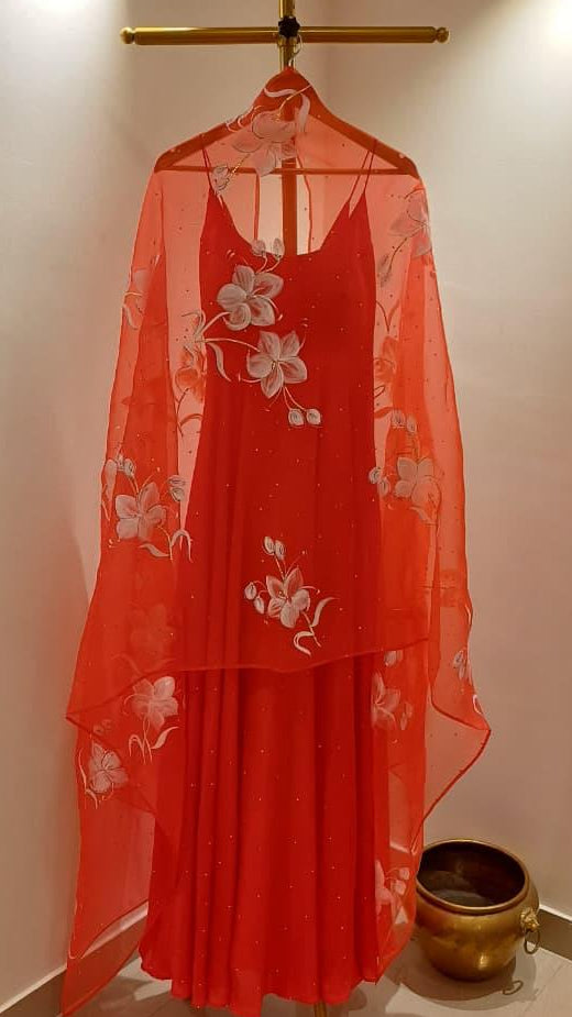 Lilies on red organza duppata with Sitara’s paired with a silk plain flared kurta with Sitara’s