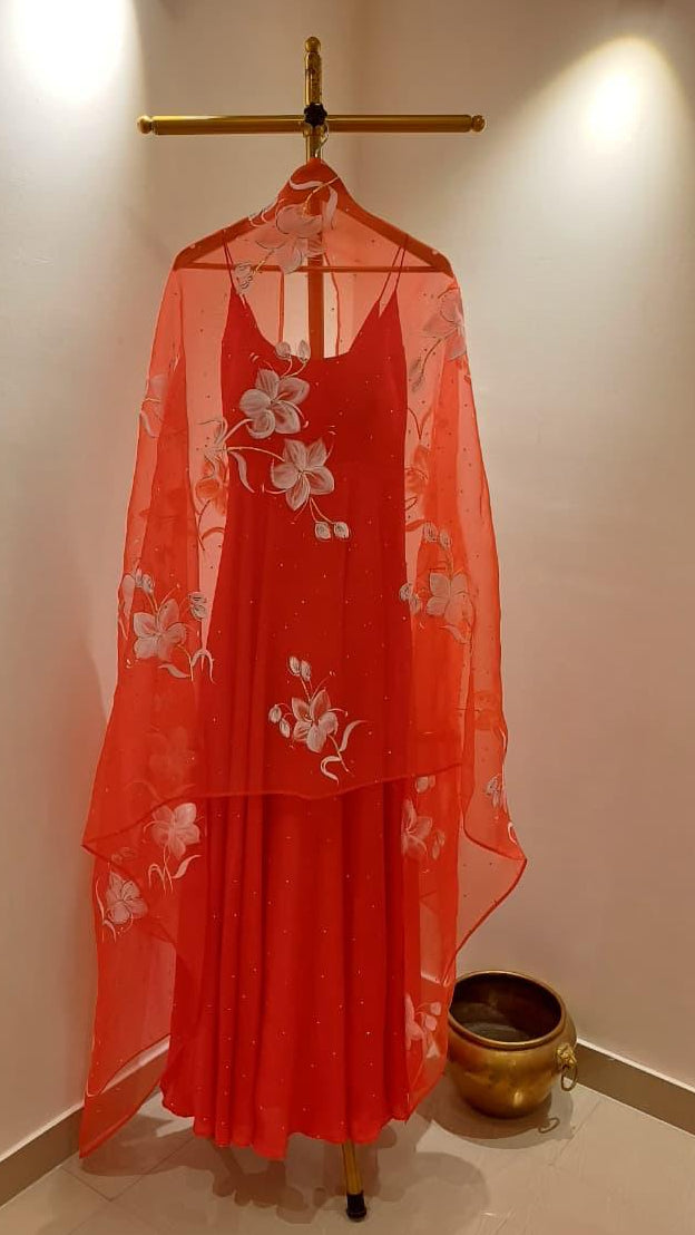 Lilies on red organza duppata with Sitara’s paired with a silk plain flared kurta with Sitara’s