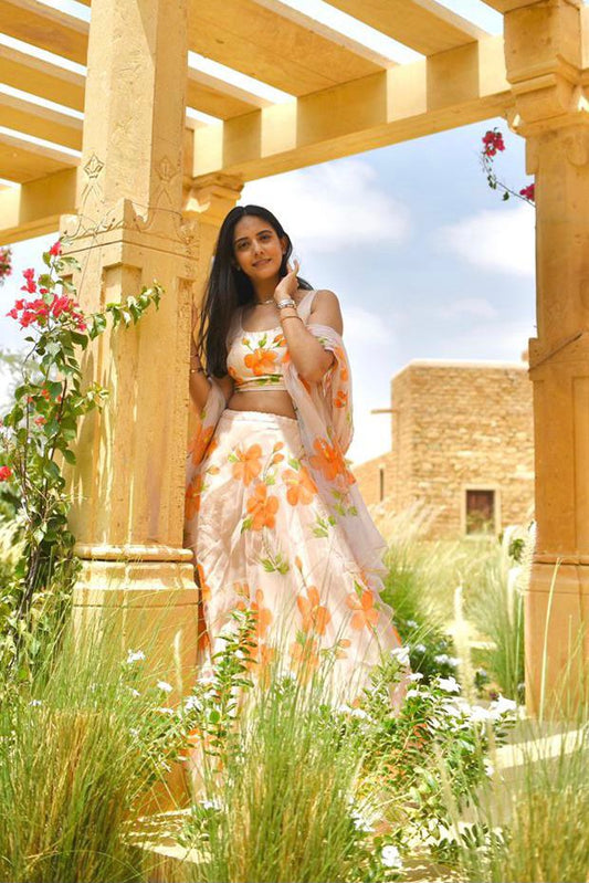 Saffron Hibiscus roses on dull rose lehenga