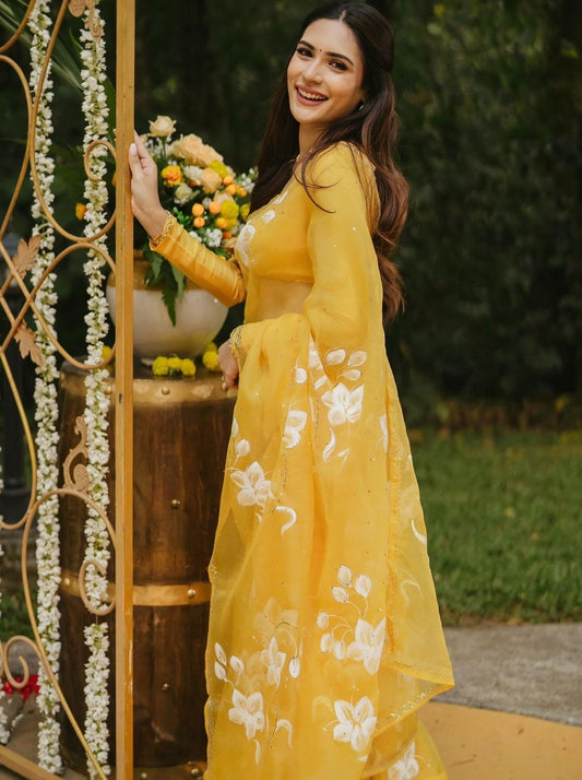 Lilies on Haldi Yellow organza saree with Sequins