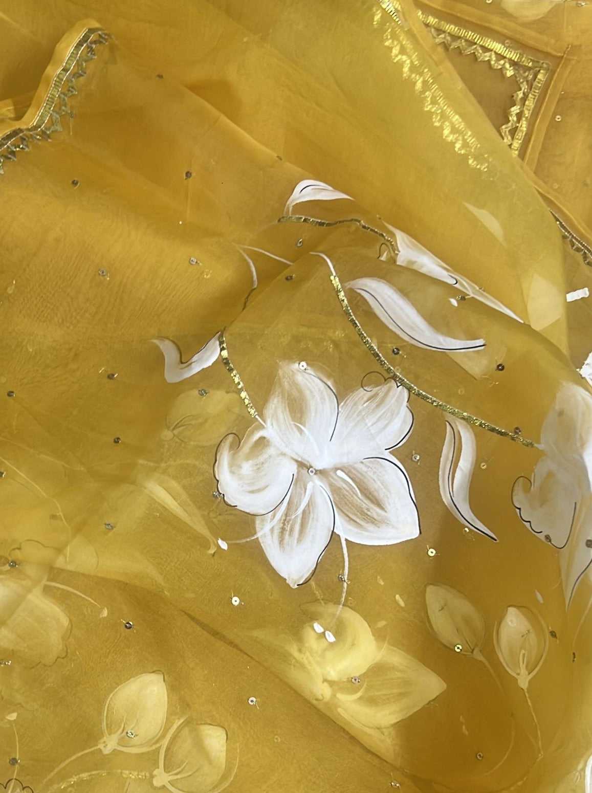 Lilies on Haldi Yellow organza saree with Sequins