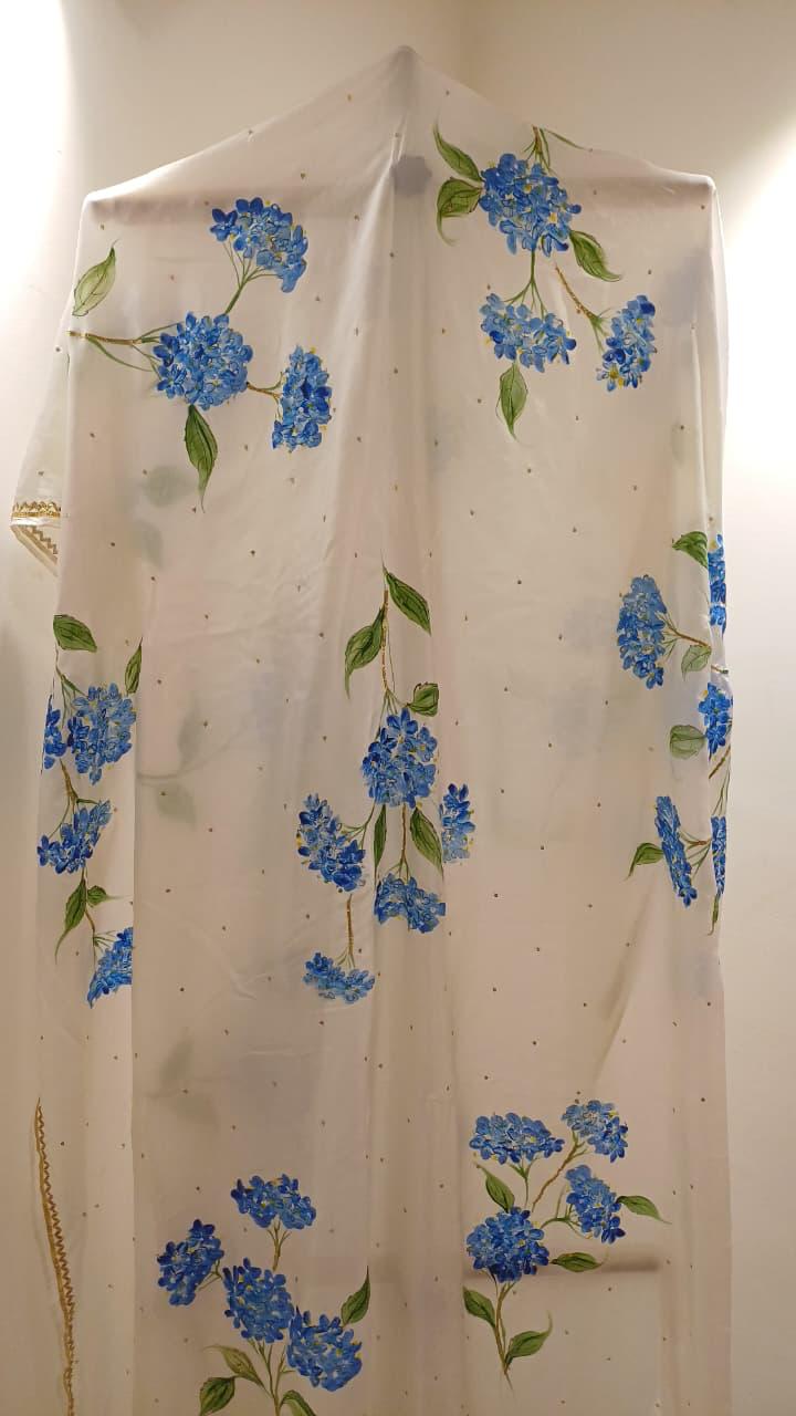 Blue hydrangeas on ivory pure silk saree with Sitara’s & border