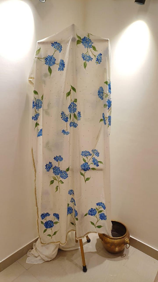 Blue hydrangeas on ivory pure silk saree with Sitara’s & border