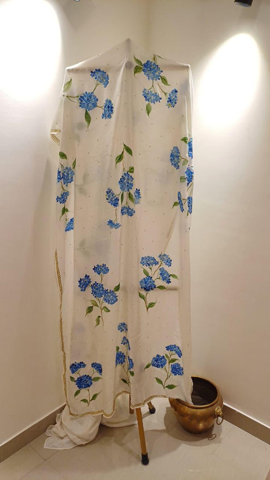 Blue hydrangeas on ivory pure silk saree with Sitara’s & border